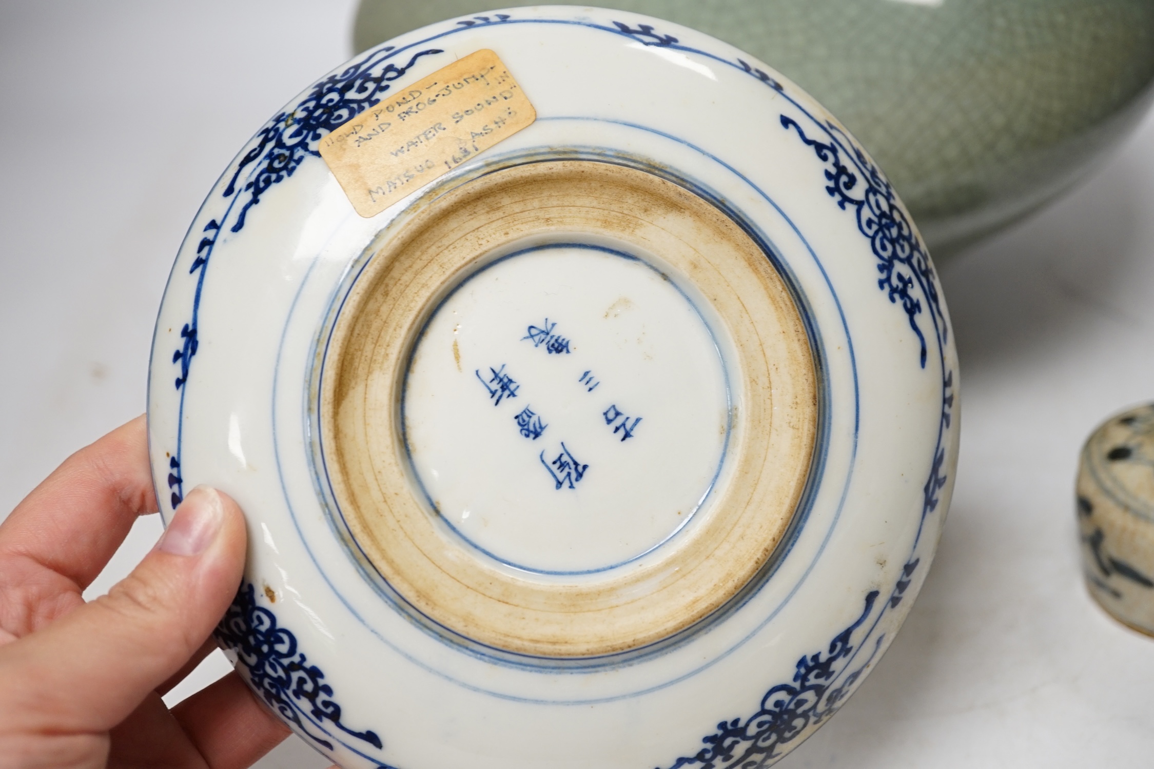Three pieces of Asian pottery items comprising a Japanese blue and white dish, a green crackleware squat vase and an early 17th century Swatow jarlet, largest 18cm high. Condition - fair